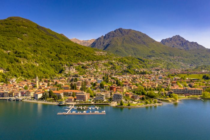 Aerial View of city of Porlezza on the shore of lake Lugano photo via Depositphotos