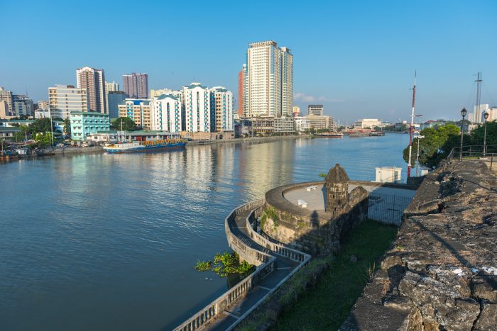 Fort Santiago and buildings along the Pasig River photo via Depositphotos