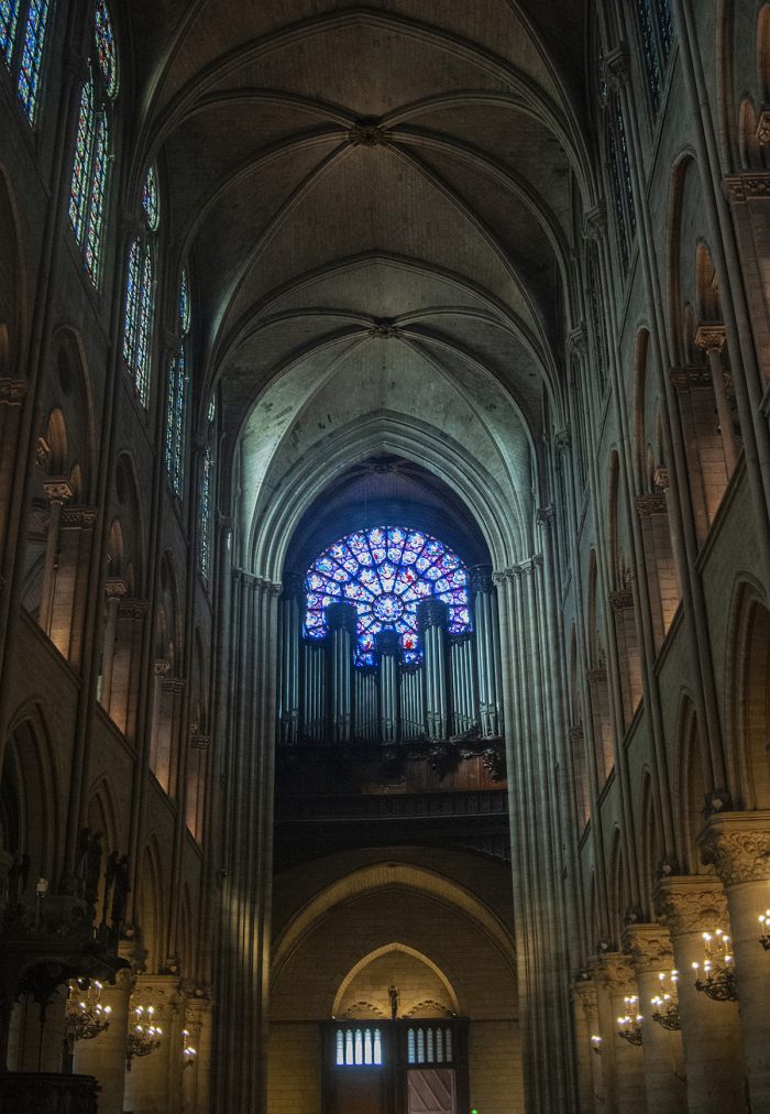 That's the organ with 8,000 pipes and five keyboards above the entrance with one of the rose windows behind it.