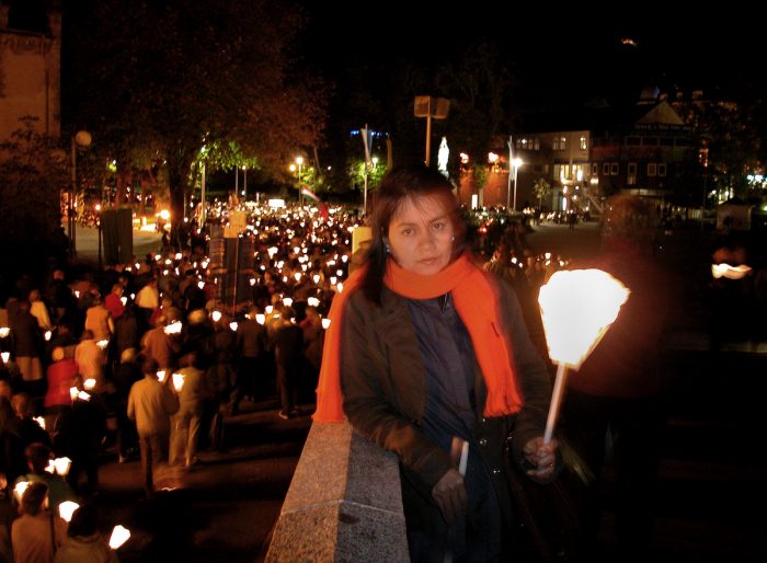 We joined the procession with our lit candles as it passed by the ramp going up to the basilica. It was a beautiful cold night with a full moon up above.