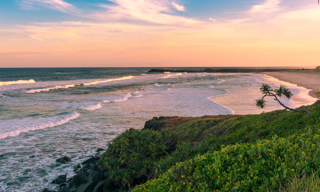 The beach view with pinky sunset in summer time on the beach in Ballina, Byron bay, Australia photo via Depositphotos