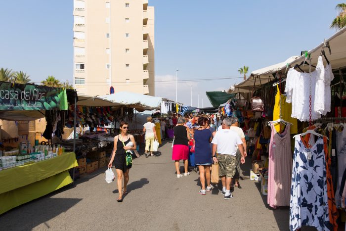 Spanish street market busy with people buying and selling at La Mata, Torrevieja, Spain photo via Depositphotos