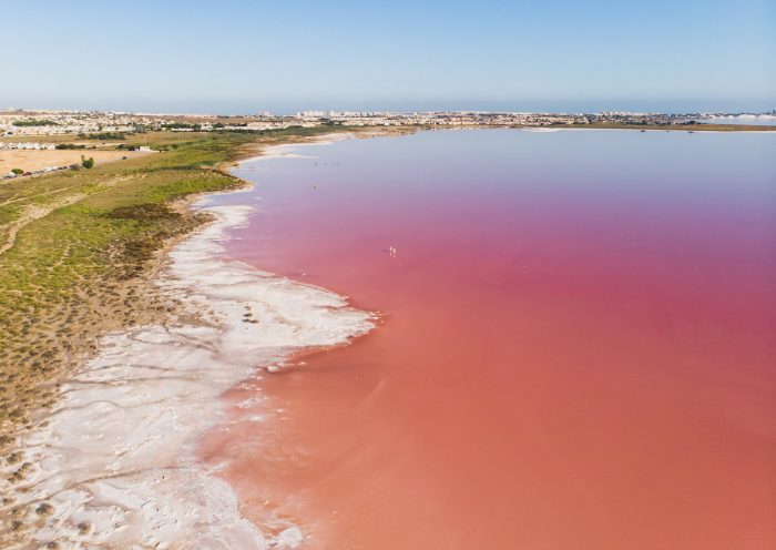 Beautiful aerial wide vibrant summer view of las Salinas de Torrevieja, The Pink Lake Of Torrevieja photo via Depositphotos