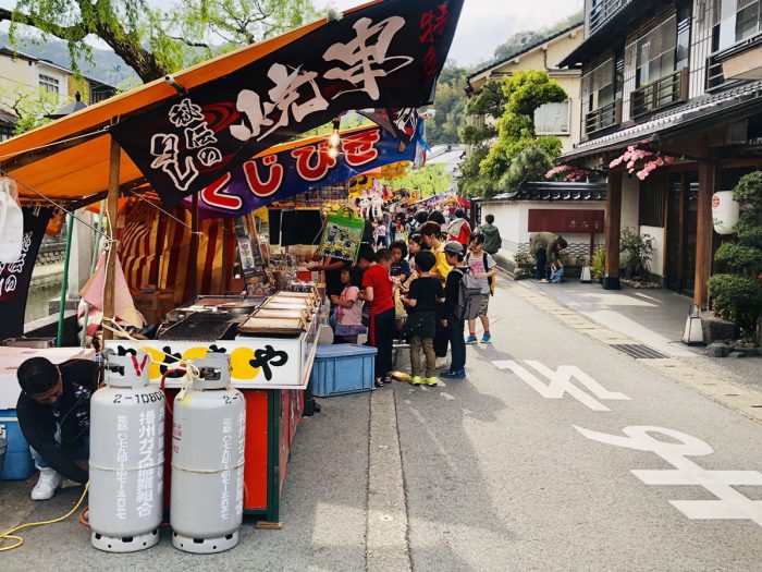 Colorful stalls alongside the river during the festival**