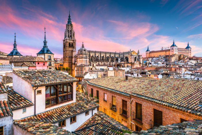 Toledo, Spain cathedral and rooftops at dawn via Depositphotos